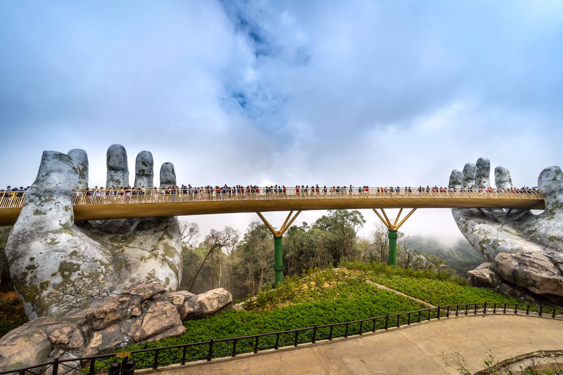 Golden Bridge in Da Nang held by giant stone hands, a popular tourist attraction.
