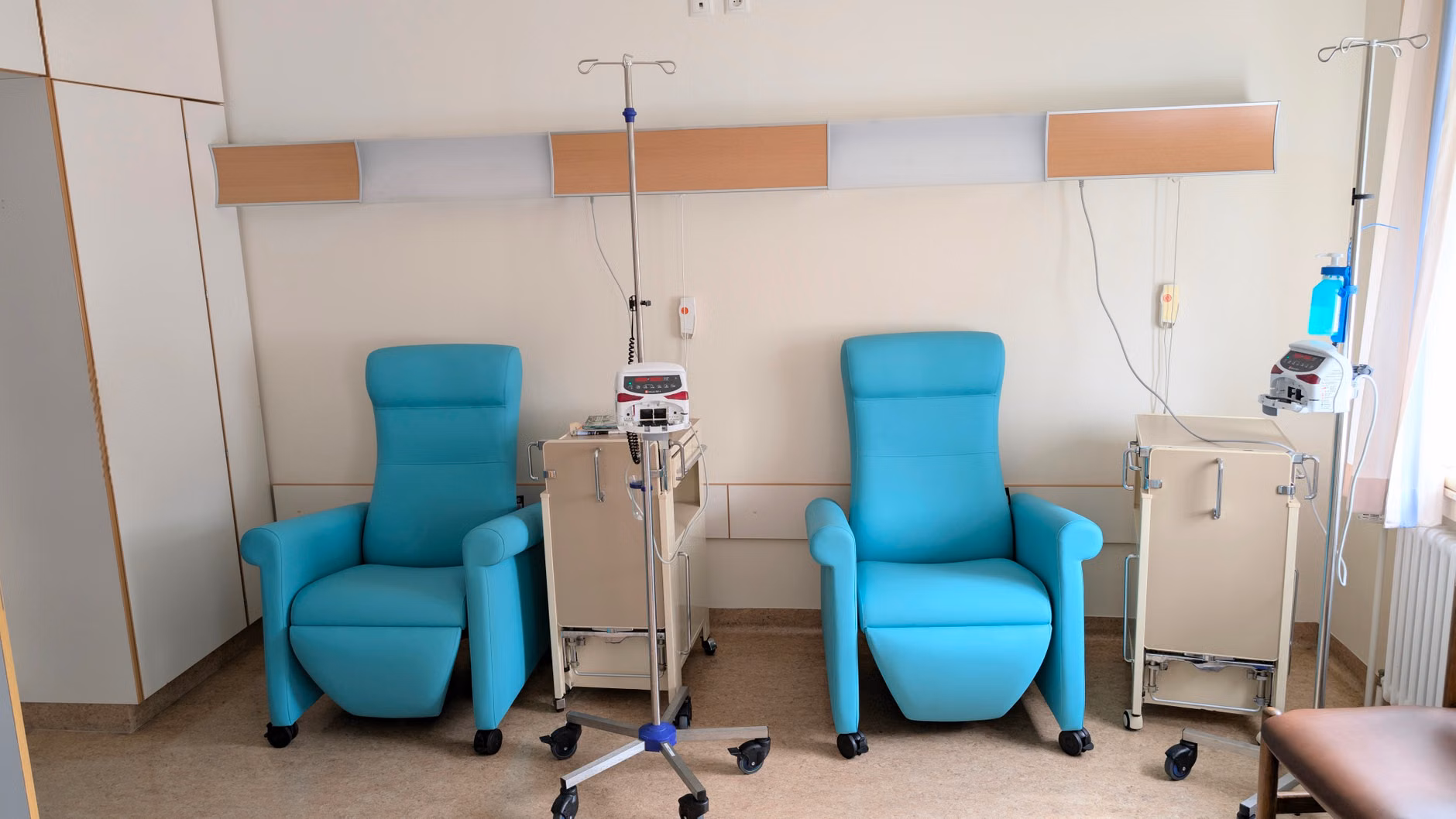 Calm hospital room featuring infusion chairs and equipment for chemotherapy treatment.